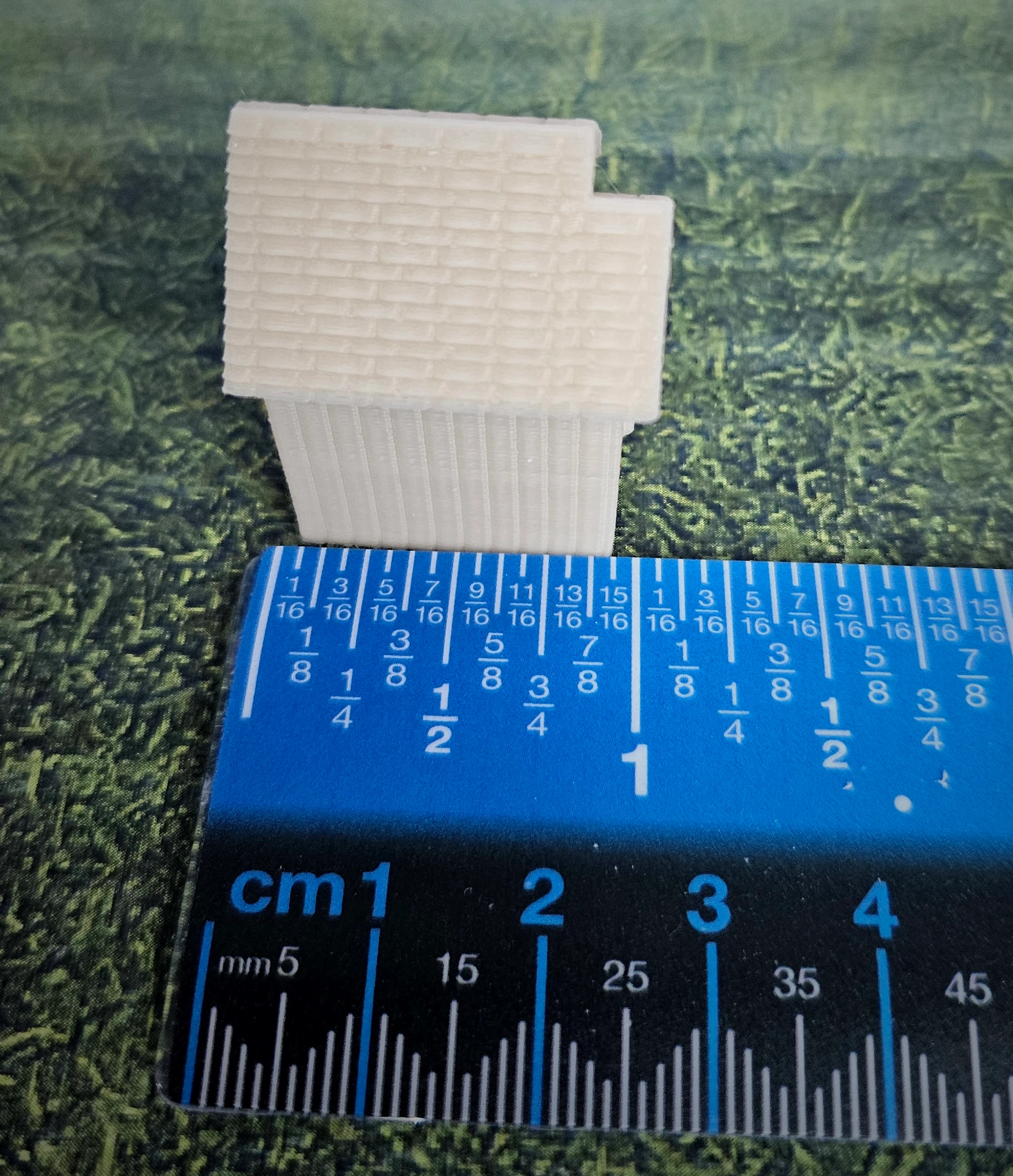 Finished scenic example of N scale waterwheel with medium building